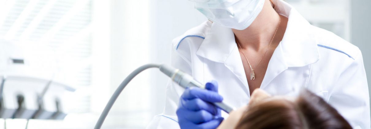 Dentist treating a patient in the dental chair